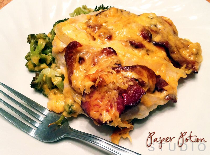 Homepage post card 2: Baked chicken breast topped with melted cheddar and crispy bacon beside broccoli florets on a white plate with a silver fork